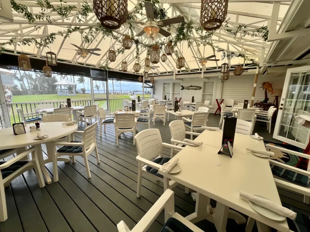 The open-air porch at Tarpon Lodge is ready for a casually elegant lunch or dinner.